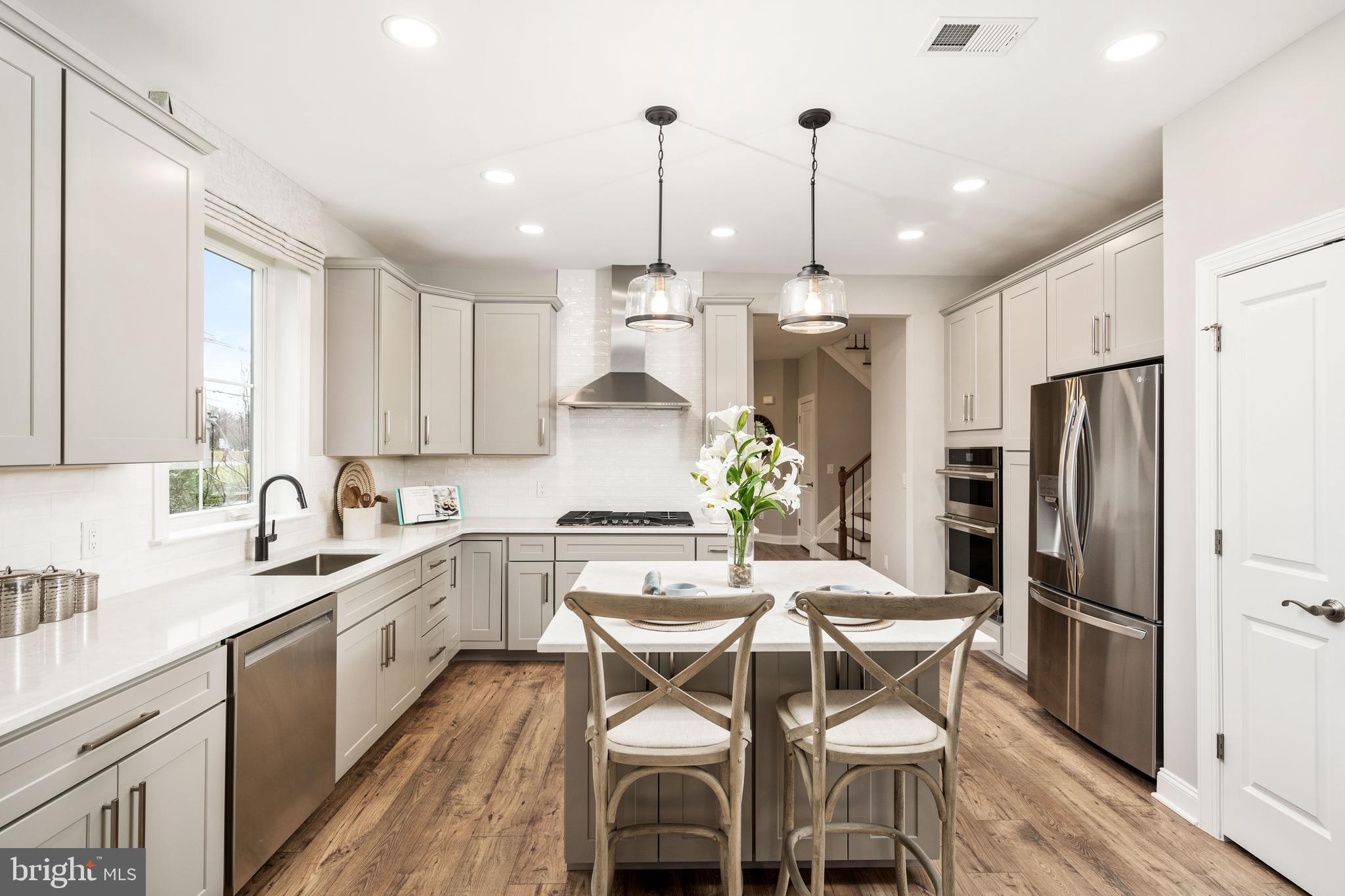44 Kay Chiarello Way Hamilton, NJ 08690 - Photo 5 of 19 a kitchen with granite countertop a center island a sink stainless steel appliances and cabinets