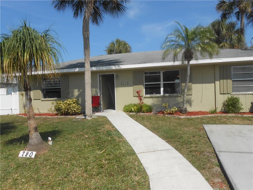 720 Coconut Road Venice, FL 34293 - Photo 1 of 1 front view of house with a yard and palm trees