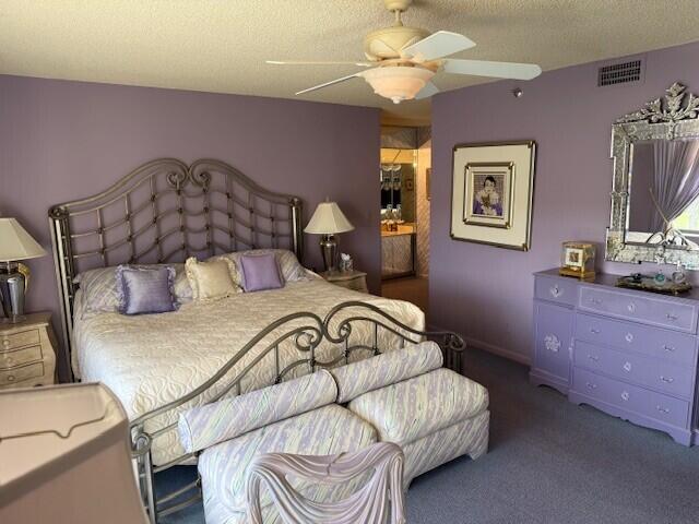 7564 Regency Lake Drive, Unit 702 Boca Raton, FL 33433 - Photo 16 of 40 a bedroom with a bed and a chandelier