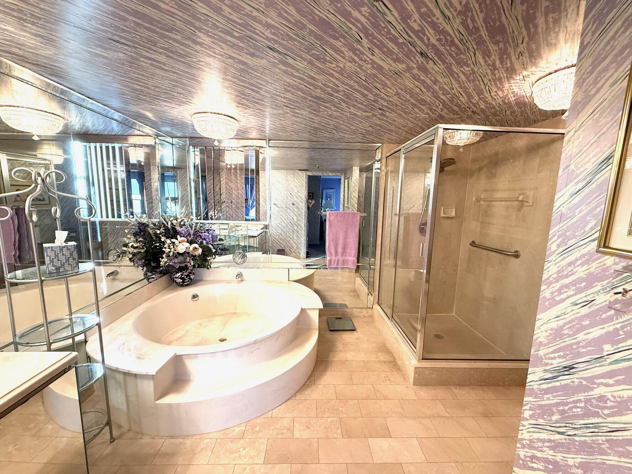 7564 Regency Lake Drive, Unit 702 Boca Raton, FL 33433 - Photo 20 of 40 a bathroom with a tub a sink and shower