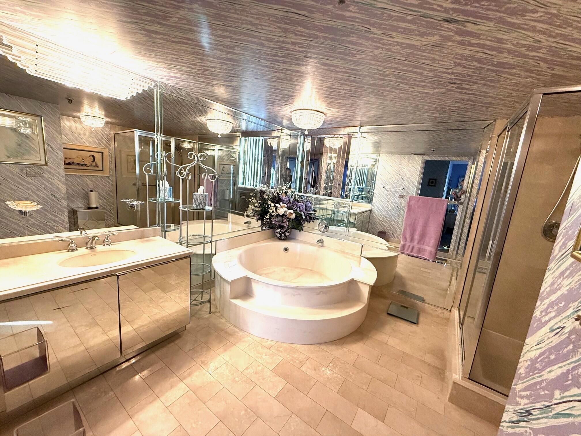 7564 Regency Lake Drive, Unit 702 Boca Raton, FL 33433 - Photo 22 of 40 a bathroom with a sink and a mirror