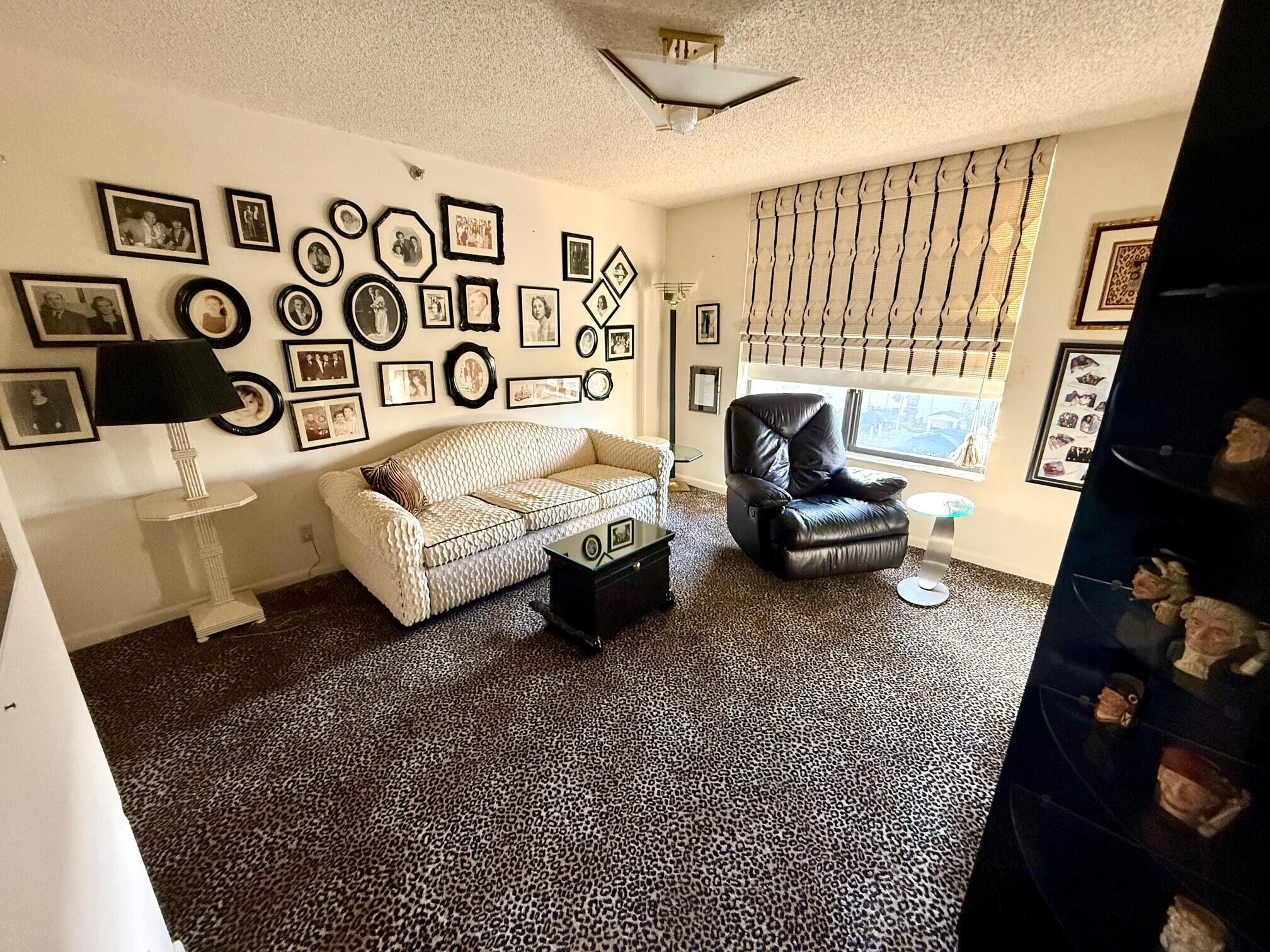 7564 Regency Lake Drive, Unit 702 Boca Raton, FL 33433 - Photo 24 of 40 a living room with furniture and a window