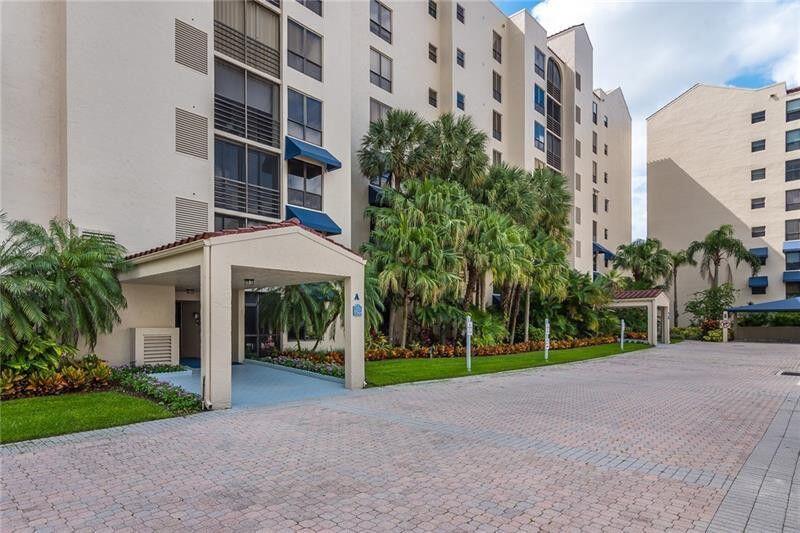 7564 Regency Lake Drive, Unit 702 Boca Raton, FL 33433 - Photo 39 of 40 a view of a building with a yard