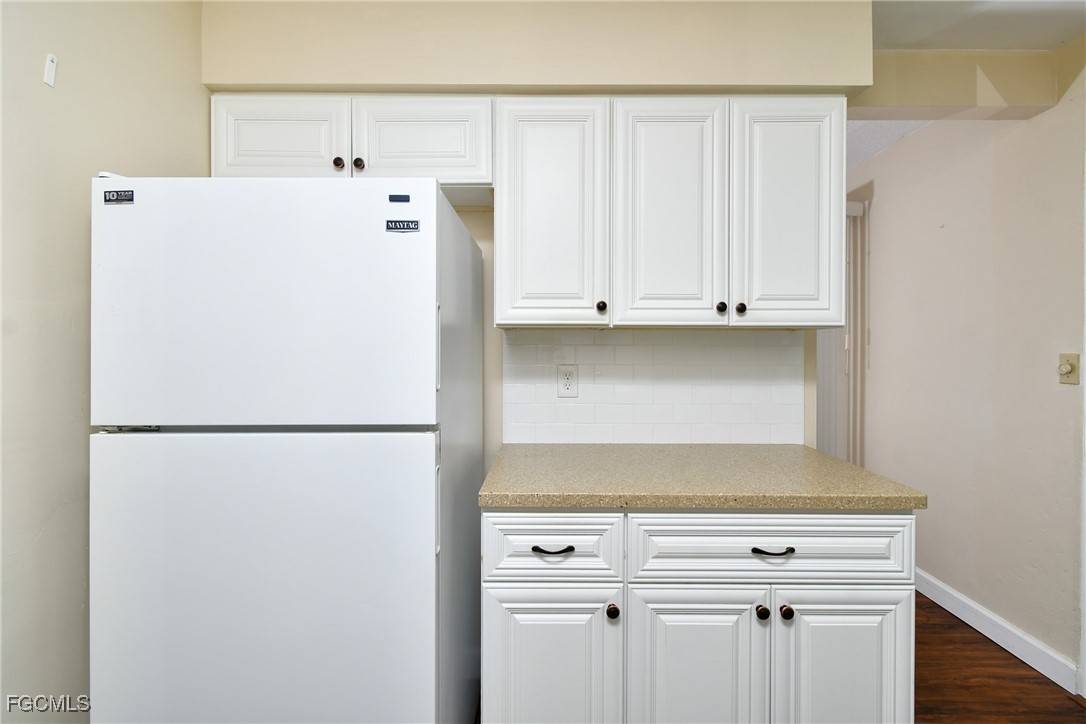 13 Hamlin Court Lehigh Acres, FL 33936 - Photo 11 of 31 a white refrigerator freezer sitting inside of a kitchen