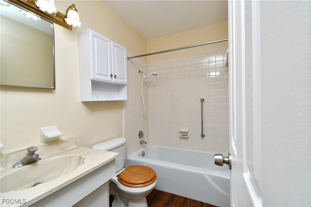 13 Hamlin Court Lehigh Acres, FL 33936 - Photo 15 of 31 a bathroom with a sink toilet and shower