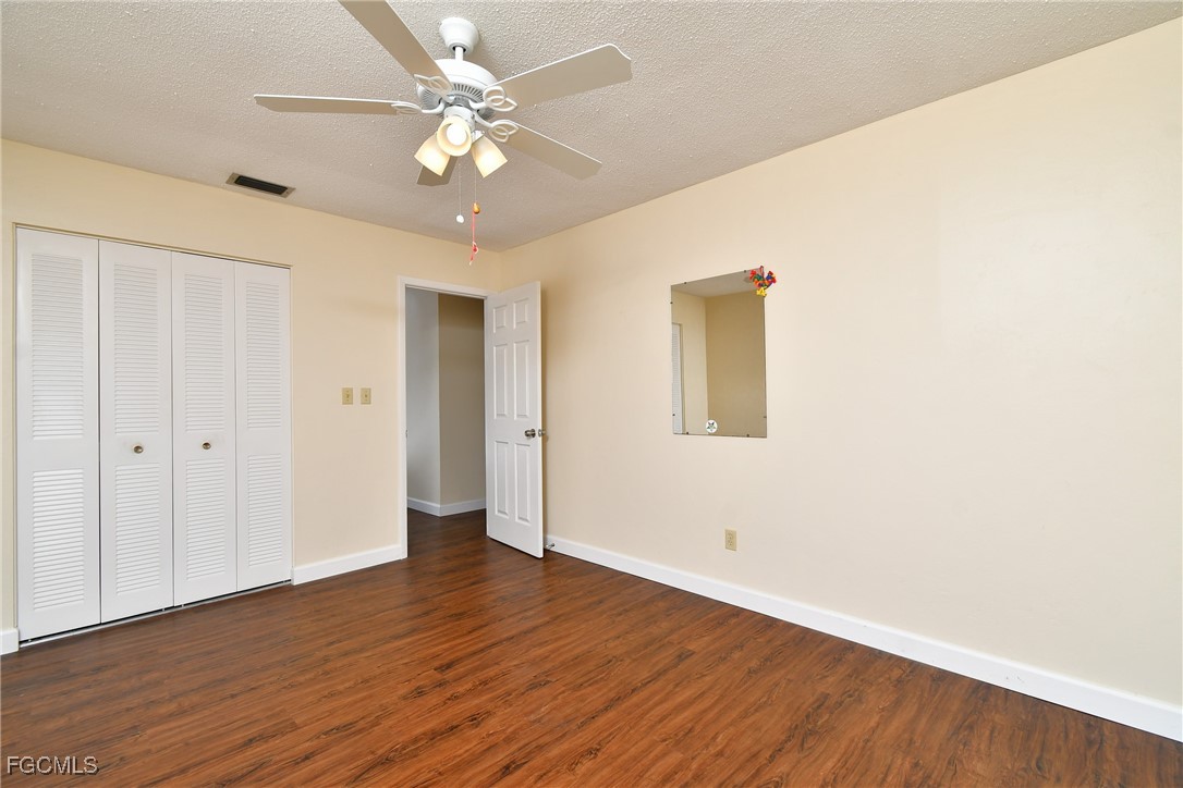 13 Hamlin Court Lehigh Acres, FL 33936 - Photo 18 of 31 a view of an empty room with wooden floor