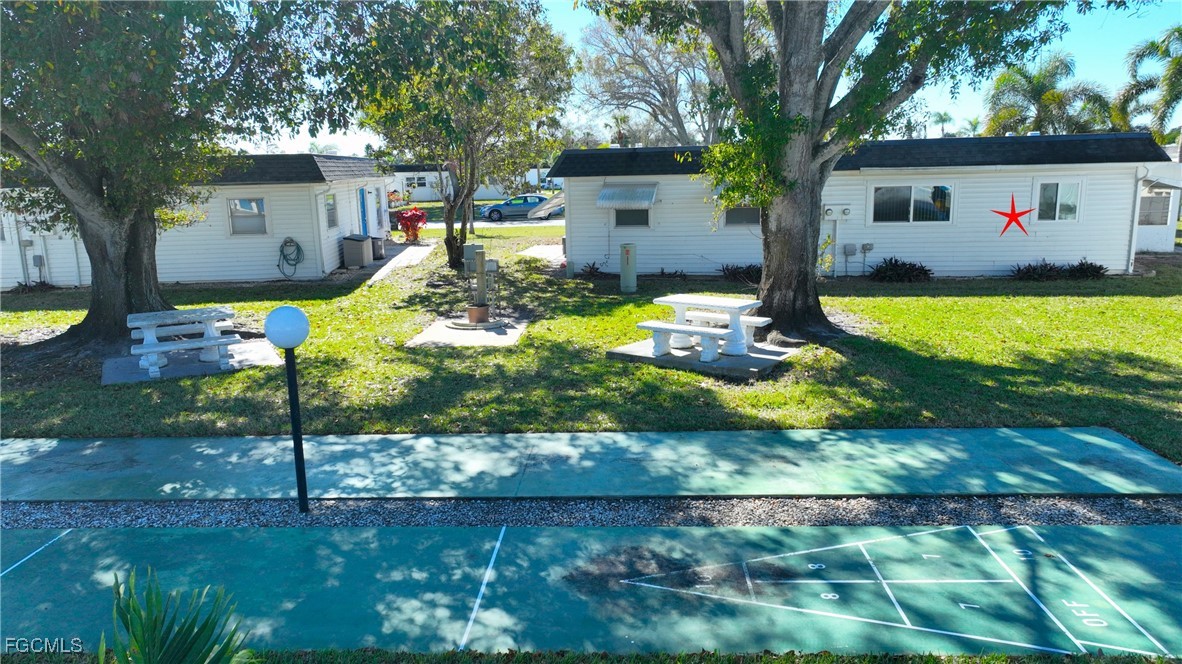 13 Hamlin Court Lehigh Acres, FL 33936 - Photo 24 of 31 a front view of house with yard and green space