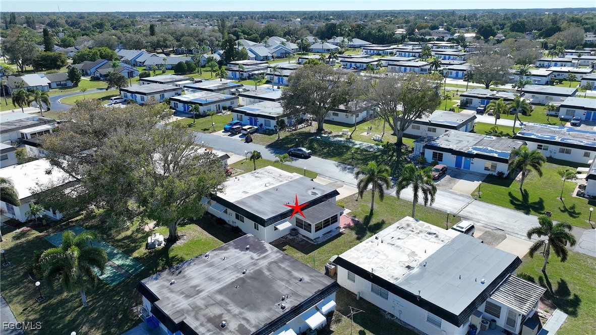 13 Hamlin Court Lehigh Acres, FL 33936 - Photo 31 of 31 an aerial view of a house with a garden and lake view