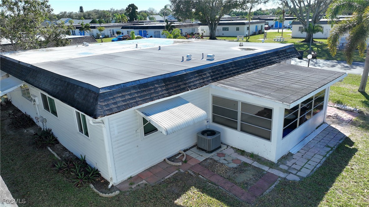 13 Hamlin Court Lehigh Acres, FL 33936 - Photo 5 of 31 a view of a wooden deck and a backyard