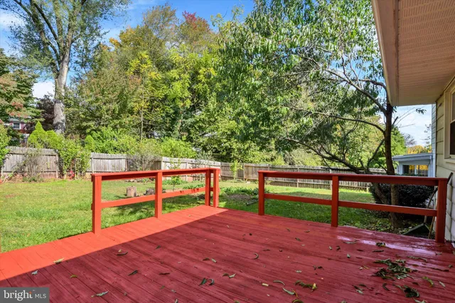a view of a yard with wooden floor and a fence