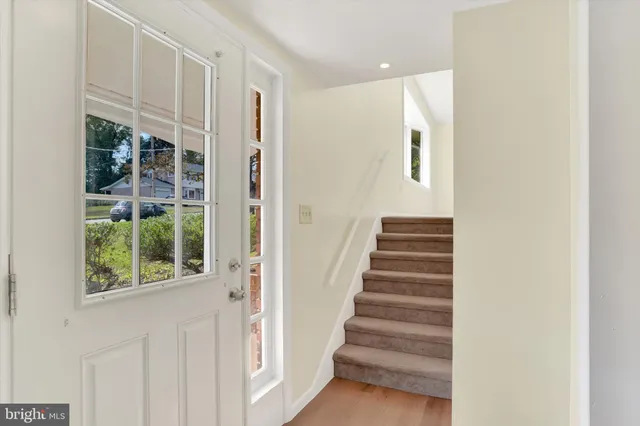 a view of entryway with wooden floor and stairs