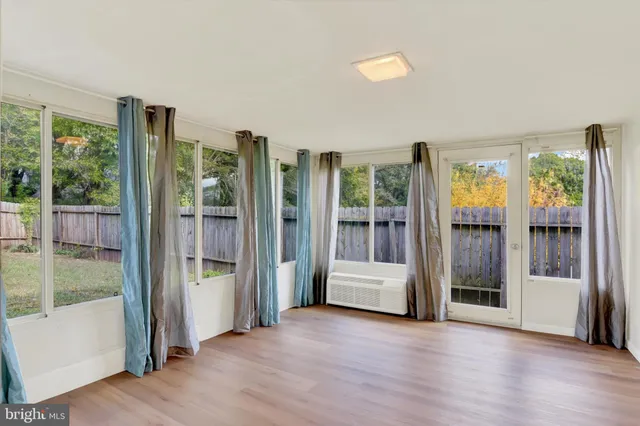 a view of an entryway with wooden floor and door