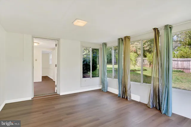 a view of an empty room with glass door