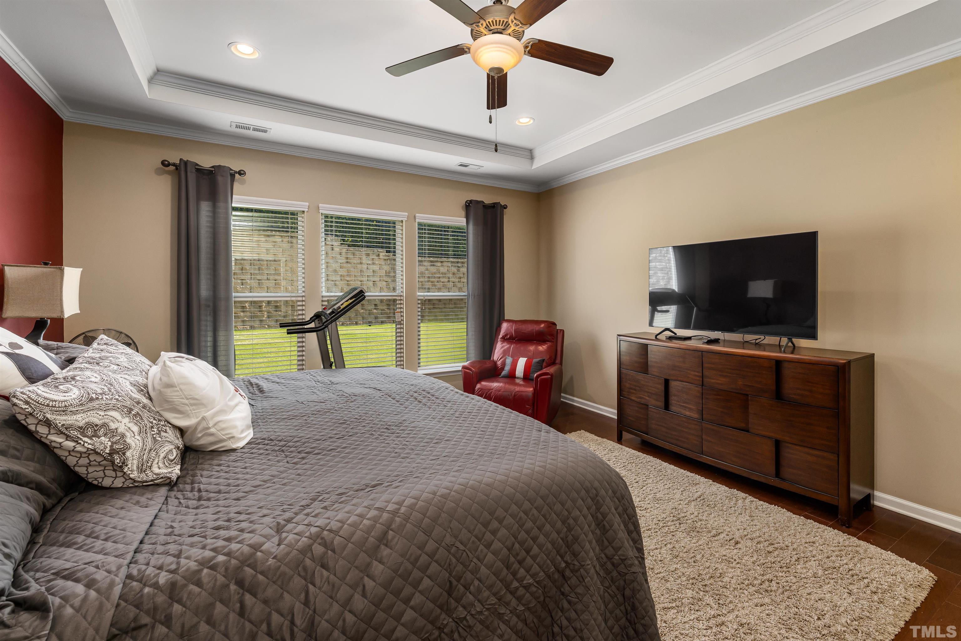 1115 Hooper Place Durham, NC 27703 - Photo 15 of 40 a bedroom with a bed and a flat tv screen on dresser