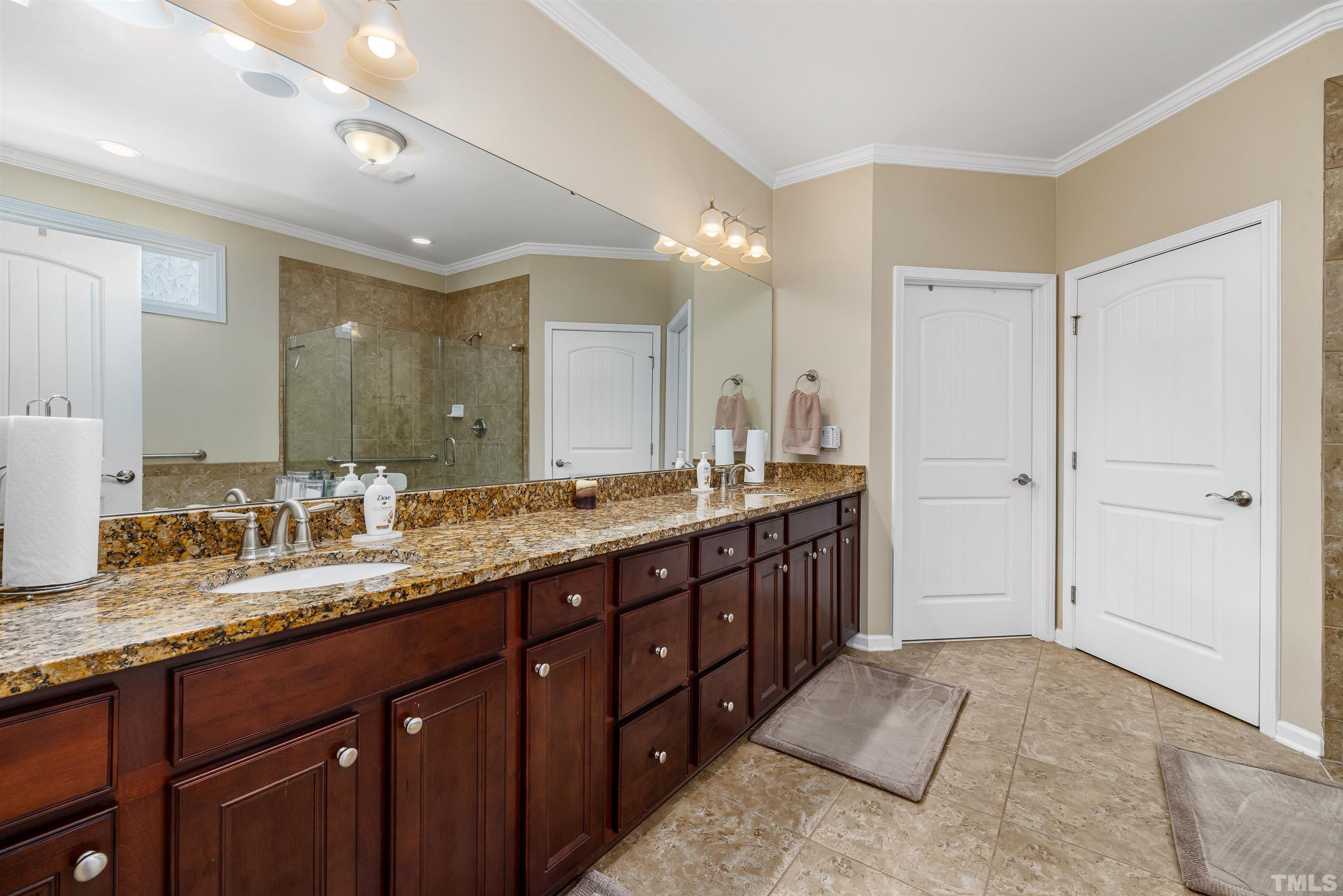 1115 Hooper Place Durham, NC 27703 - Photo 16 of 40 a spacious bathroom with a double vanity sink shower and a mirror