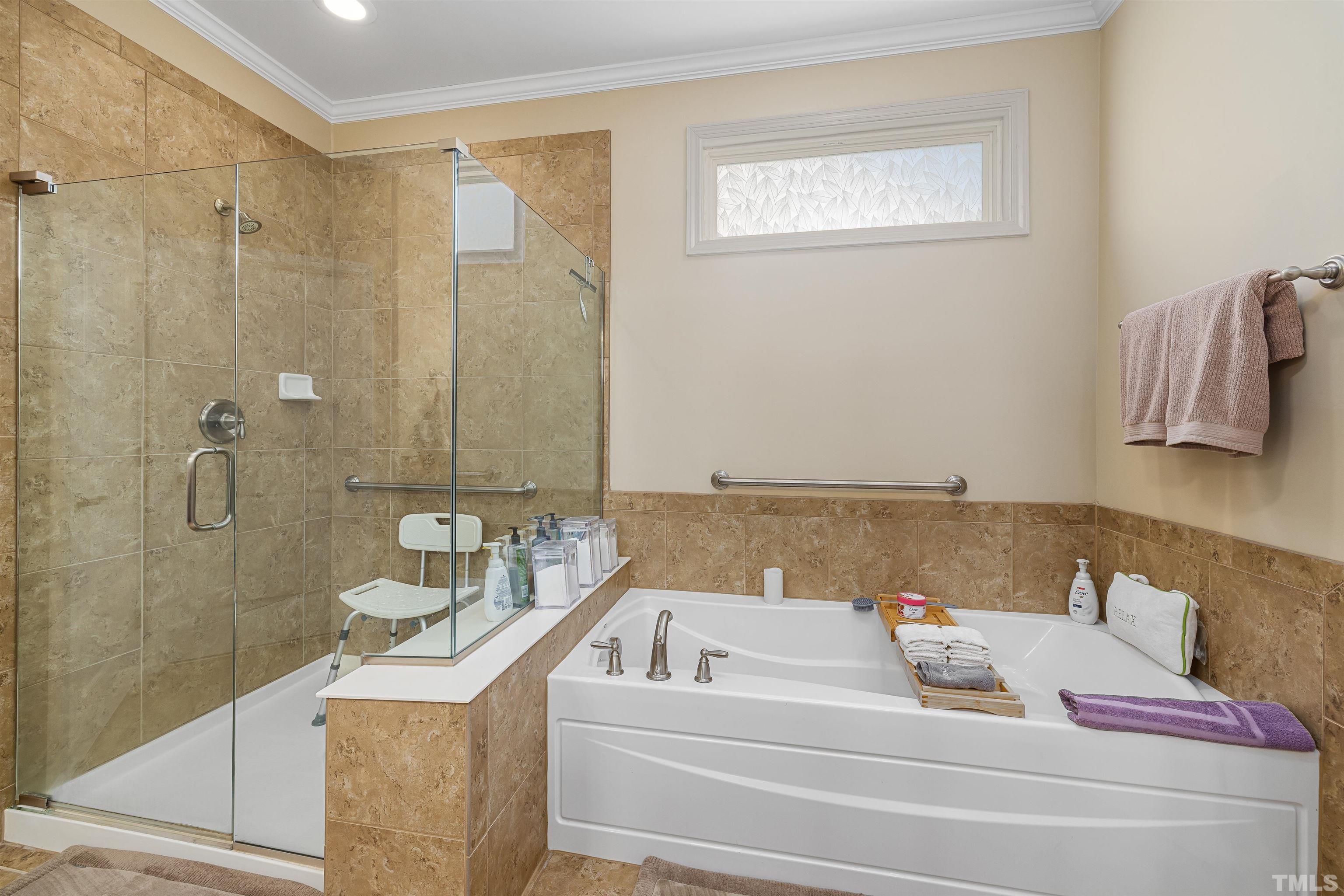 1115 Hooper Place Durham, NC 27703 - Photo 17 of 40 a bathroom with a bathtub and shower