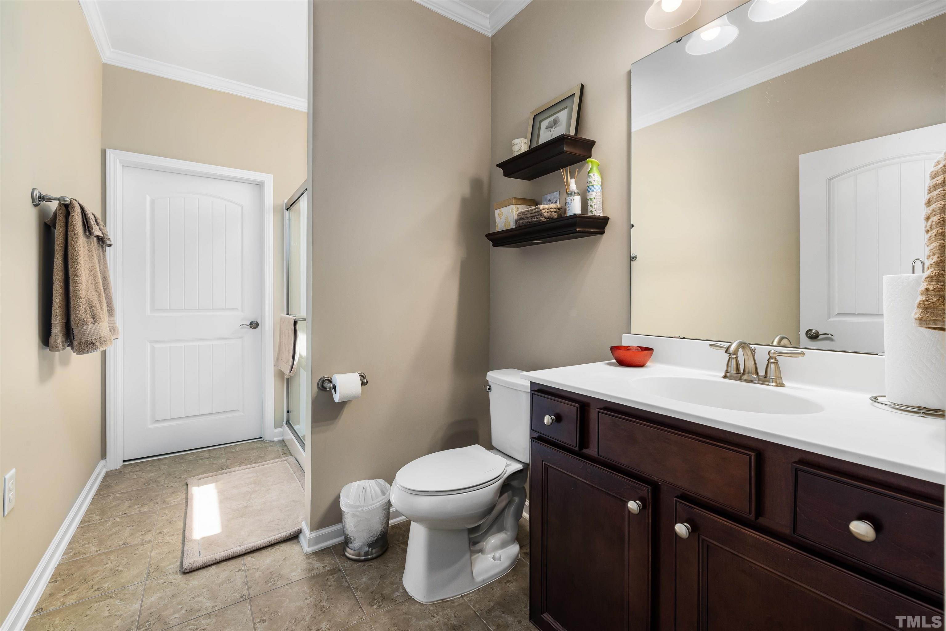 1115 Hooper Place Durham, NC 27703 - Photo 24 of 40 a bathroom with a granite countertop sink a toilet and a shower