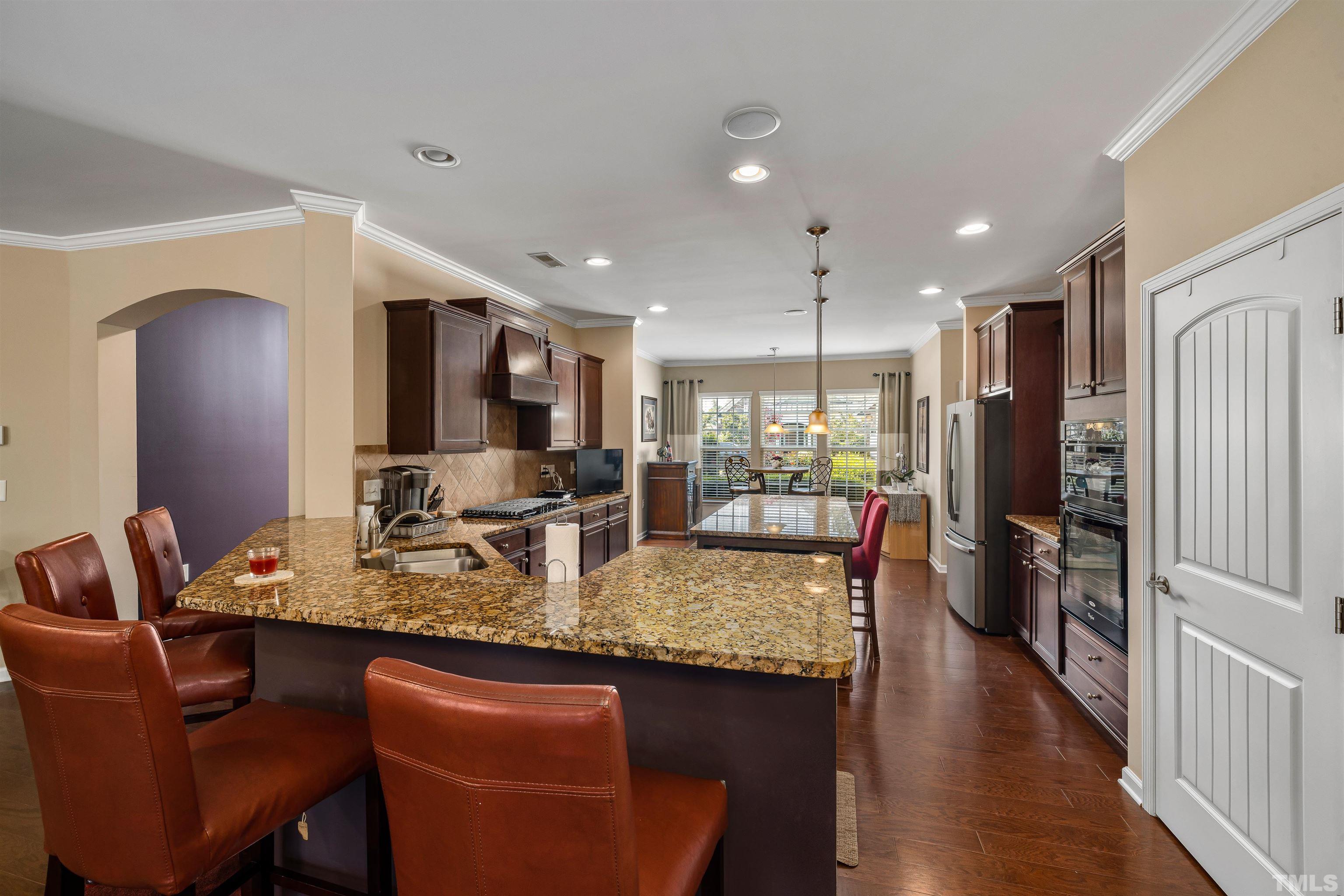 1115 Hooper Place Durham, NC 27703 - Photo 5 of 40 a dining hall with stainless steel appliances granite countertop a dining table chairs and granite counter tops