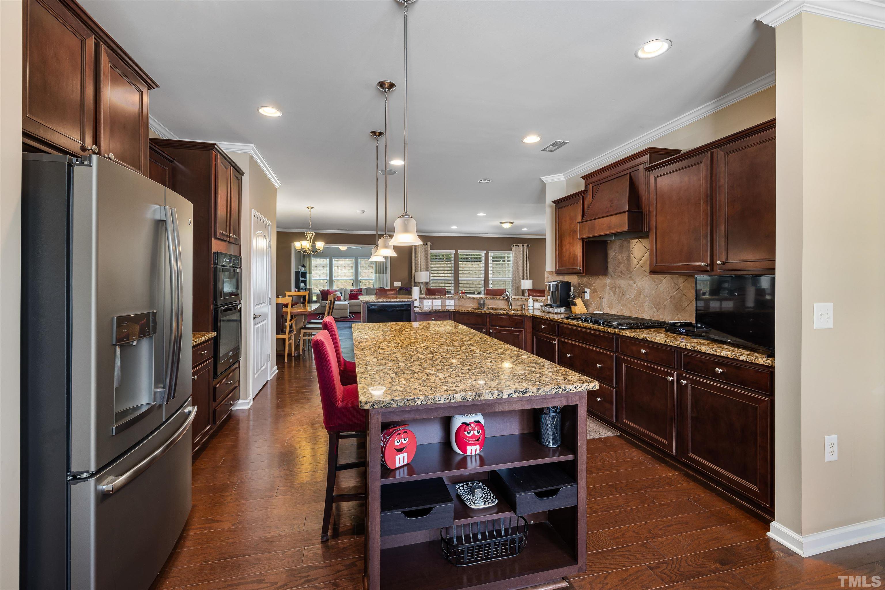 1115 Hooper Place Durham, NC 27703 - Photo 7 of 40 a kitchen with stainless steel appliances granite countertop a refrigerator a stove and a sink