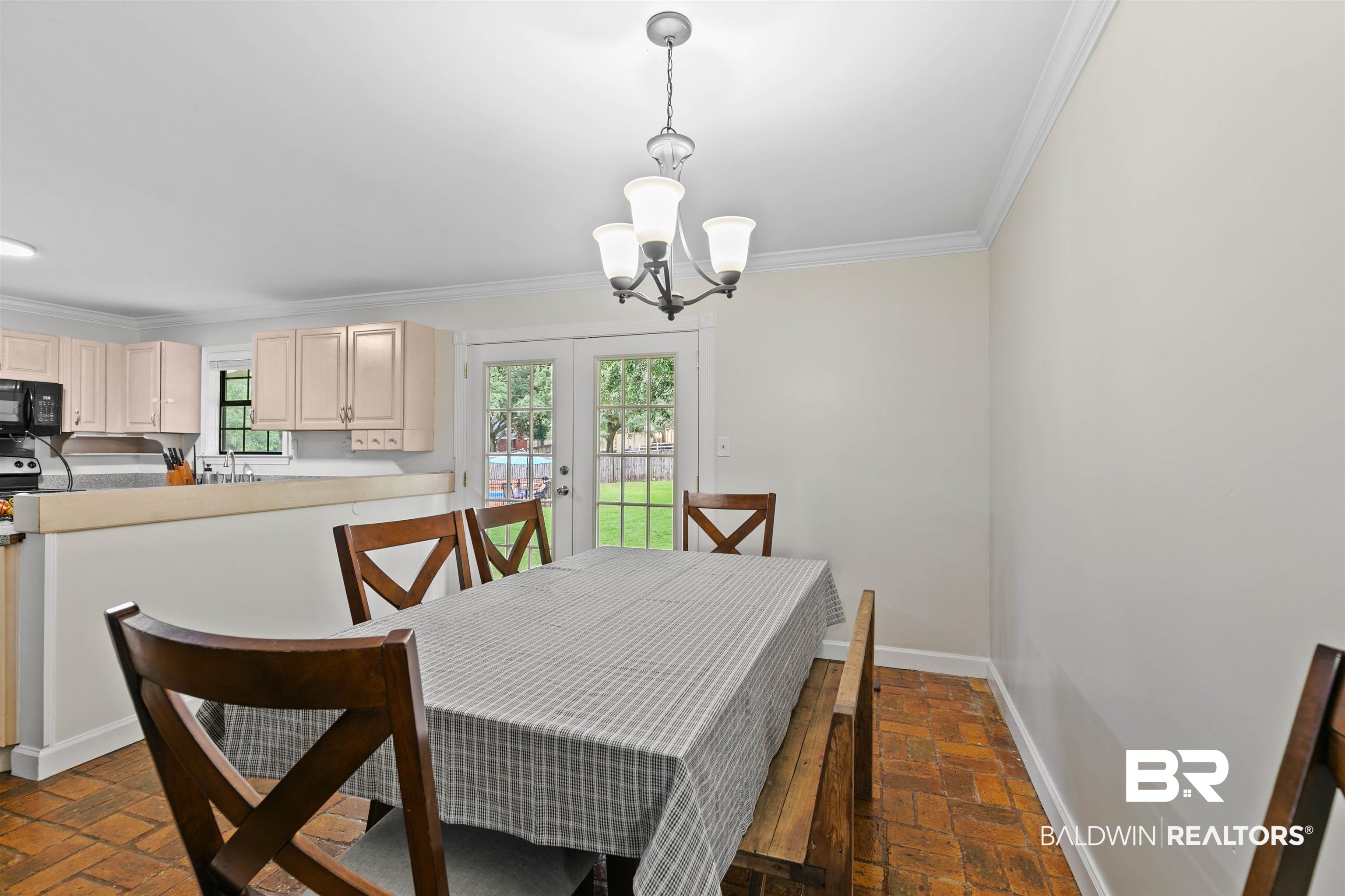 10420 Johnson Road South Mobile, AL 36695 - Photo 18 of 75 Dining area featuring brick flooring, crown molding, and a chandelier