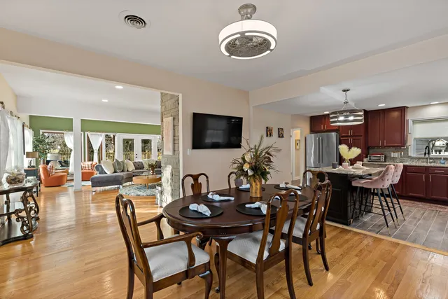 a view of a dining room with furniture window and wooden floor