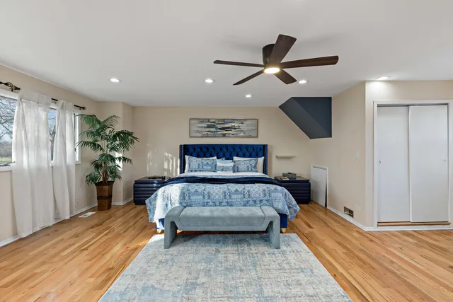 a bedroom with a large bed and a chandelier