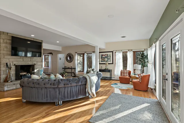 a living room with furniture wooden floor and a fireplace