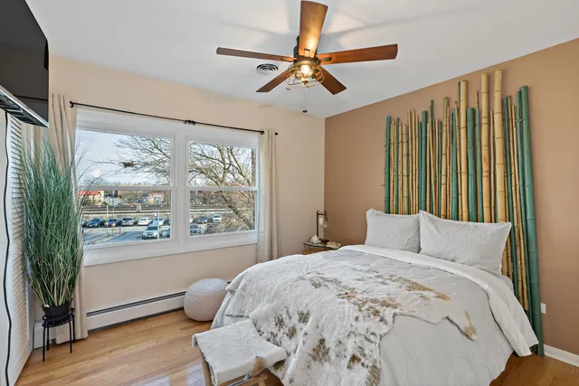 a bedroom with a large bed and a window