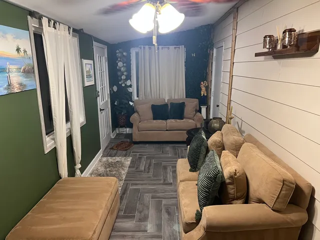 a living room with furniture and a chandelier