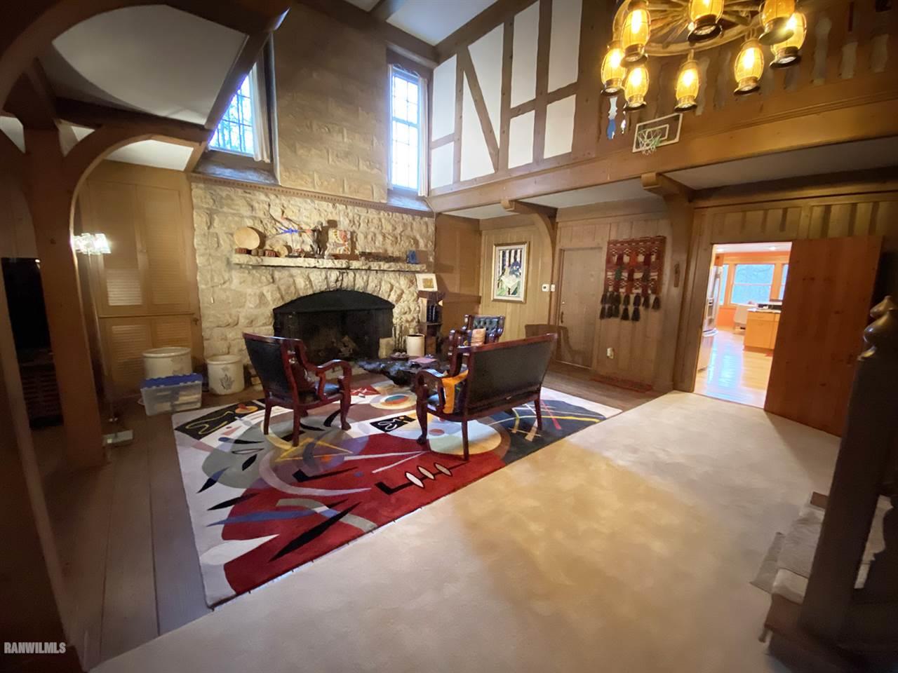 2871 West Forest Road Freeport, IL 61032 - Photo 26 of 68 a living room with furniture a fireplace and a chandelier