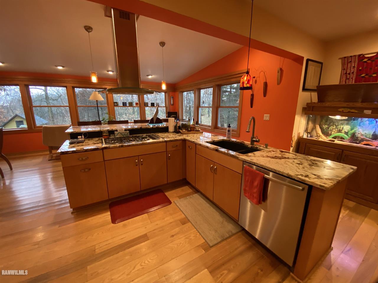 2871 West Forest Road Freeport, IL 61032 - Photo 32 of 68 a kitchen with stainless steel appliances granite countertop a sink stove and wooden floor