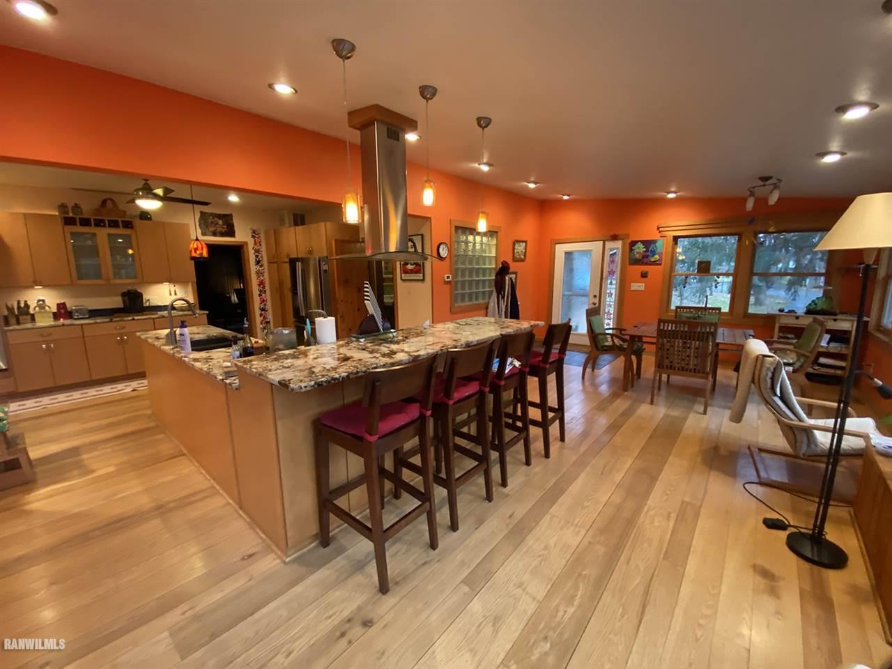 2871 West Forest Road Freeport, IL 61032 - Photo 33 of 68 a open kitchen with stainless steel appliances kitchen island granite countertop a table chairs and a stove