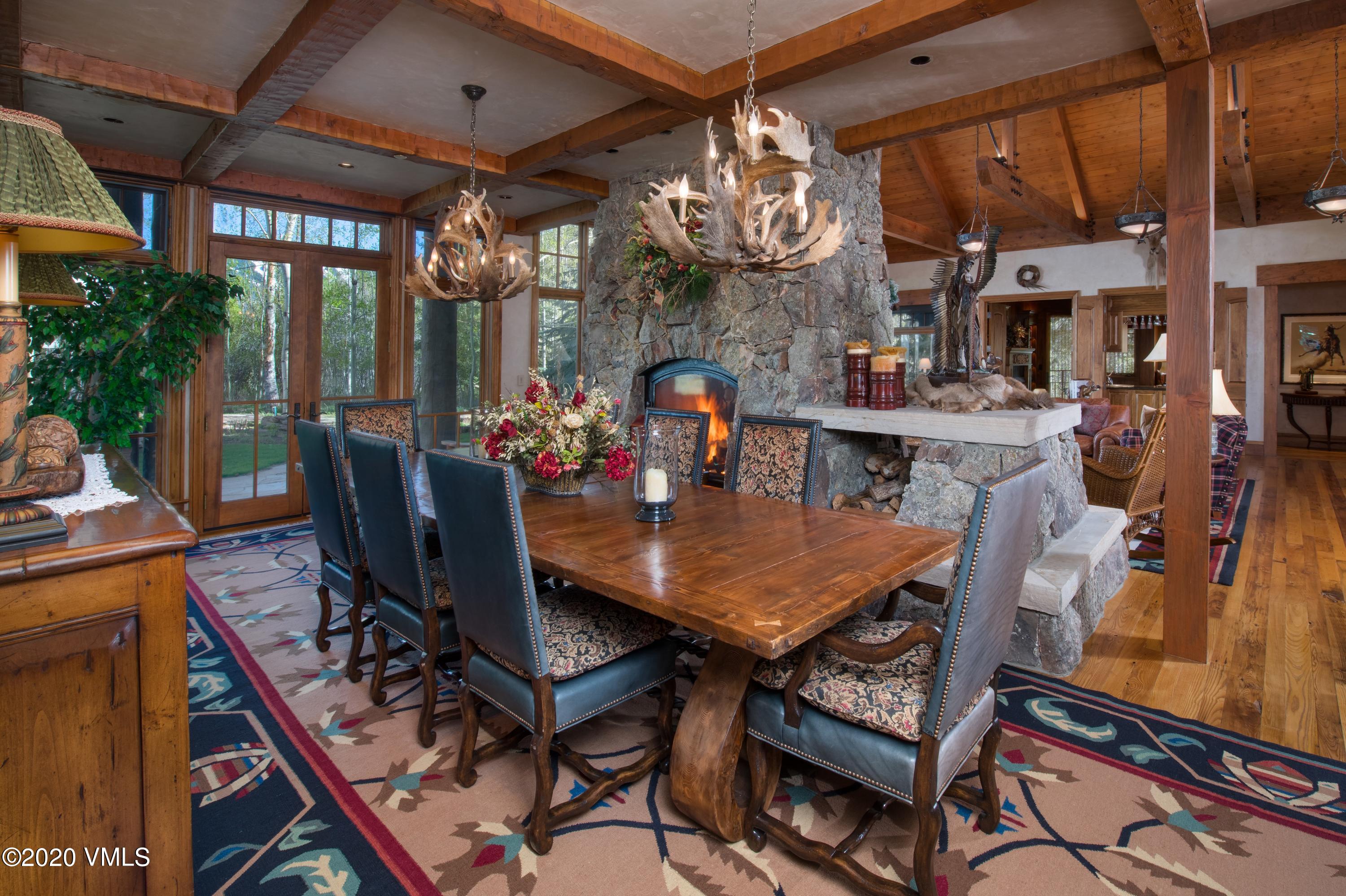 2201 Daybreak Ridge Road Beaver Creek, CO 81620 - Photo 6 of 25 a view of a dining room with furniture a chandelier and wooden floor
