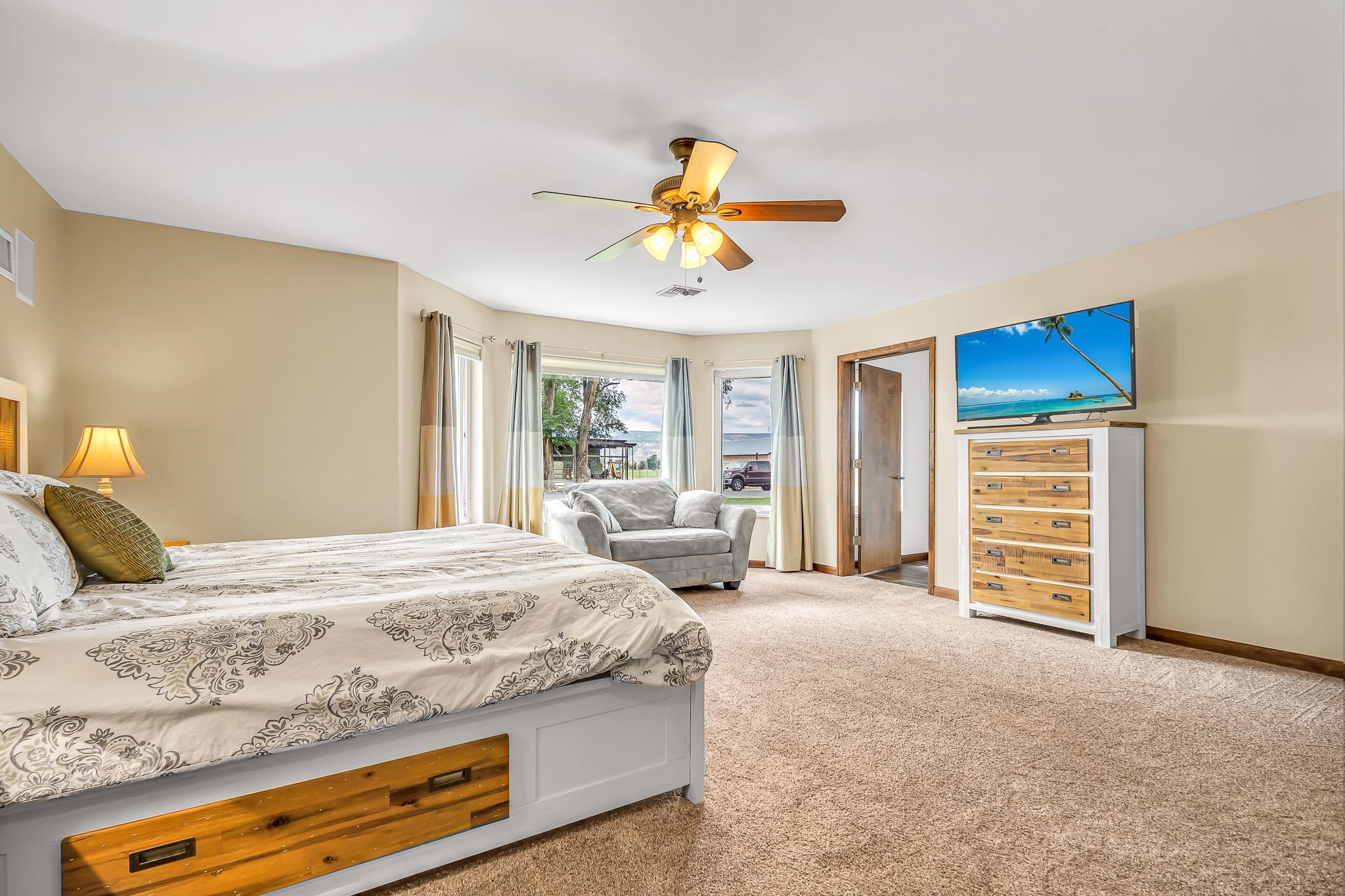 1171 20 Road Fruita, CO 81521 - Photo 14 of 42 a bedroom with a bed and a chandelier