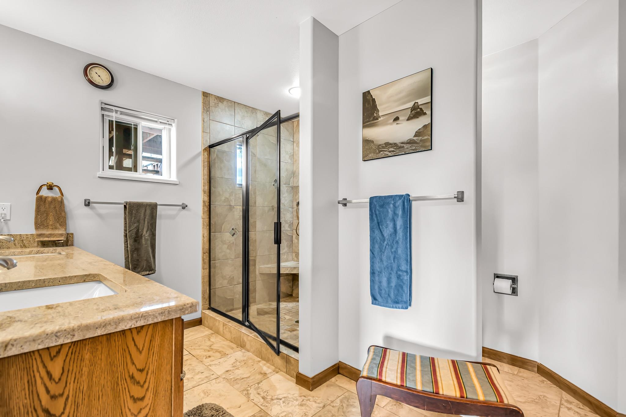 1171 20 Road Fruita, CO 81521 - Photo 16 of 42 a spacious bedroom with a bed and a view of bathroom