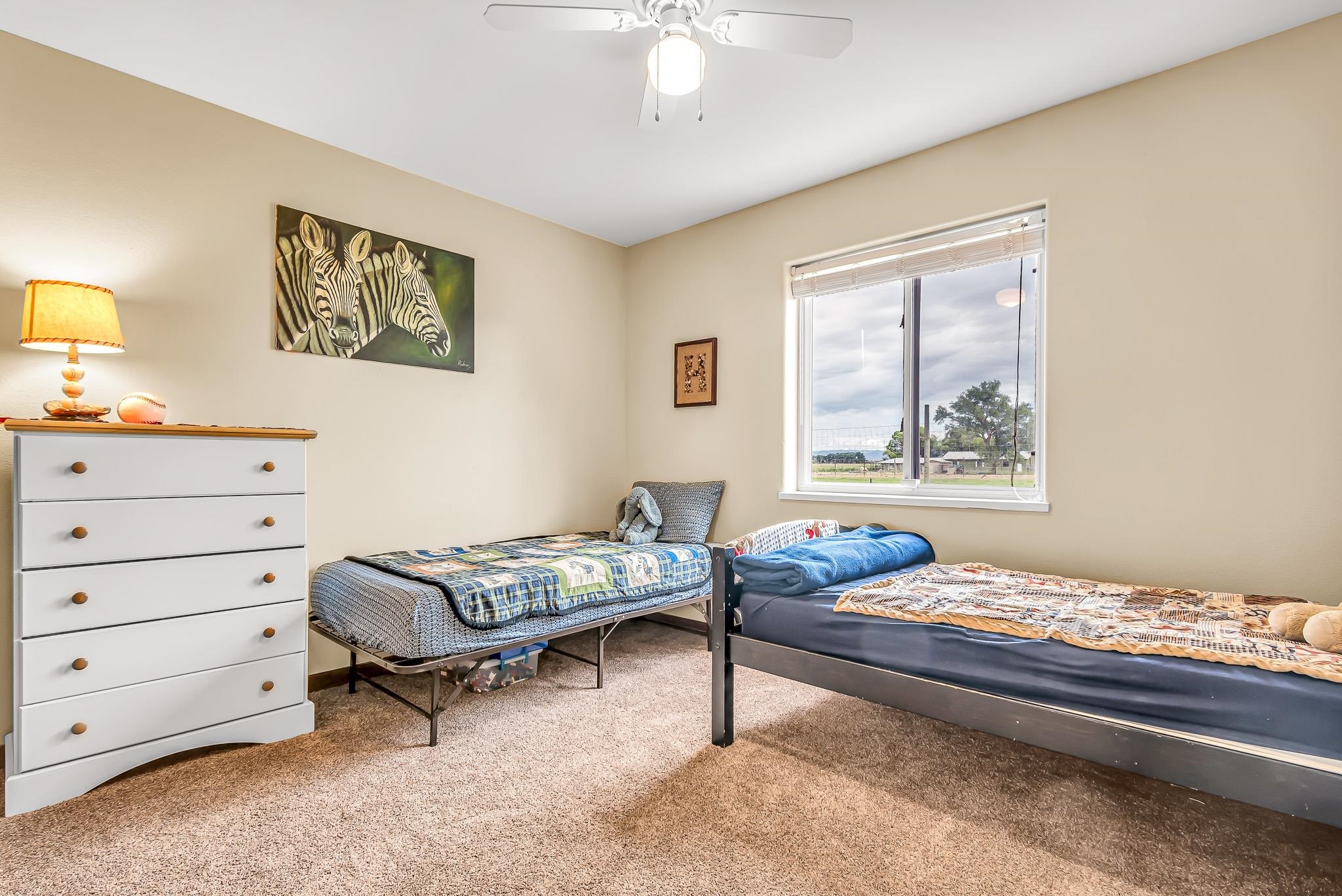 1171 20 Road Fruita, CO 81521 - Photo 18 of 42 a bedroom with furniture and a window