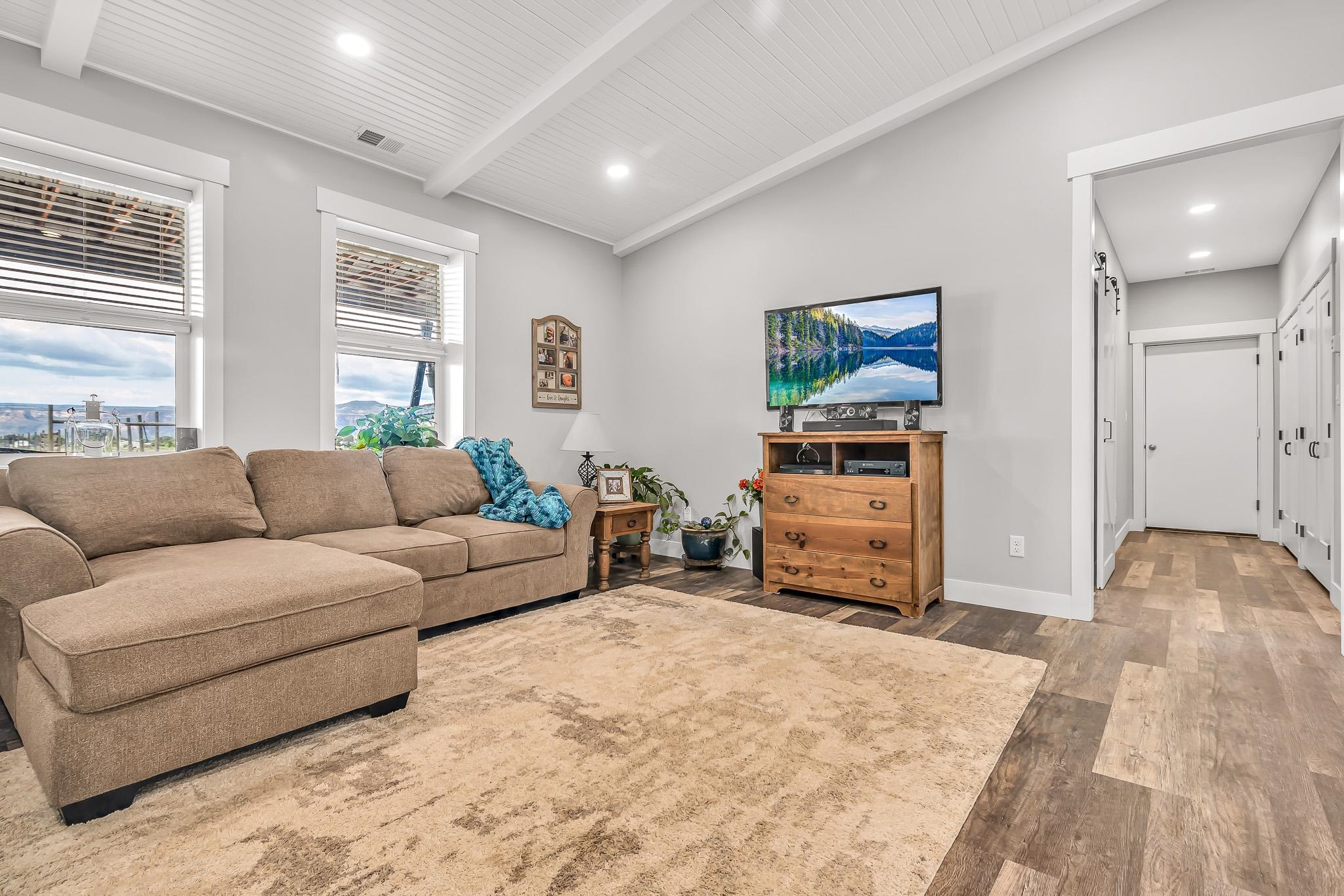 1171 20 Road Fruita, CO 81521 - Photo 26 of 42 a living room with furniture and a flat screen tv