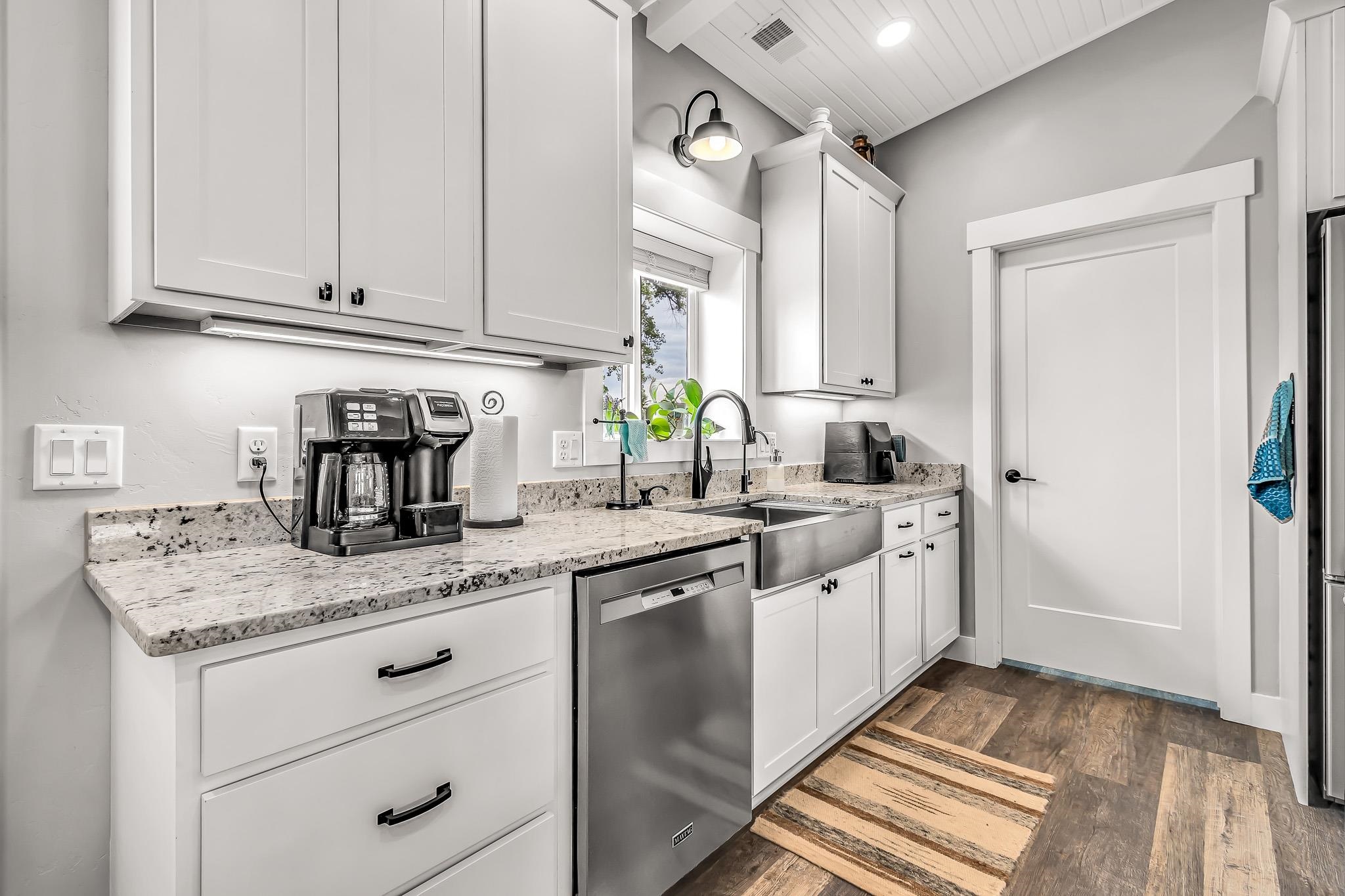 1171 20 Road Fruita, CO 81521 - Photo 28 of 42 a kitchen with granite countertop stainless steel appliances a sink and cabinets