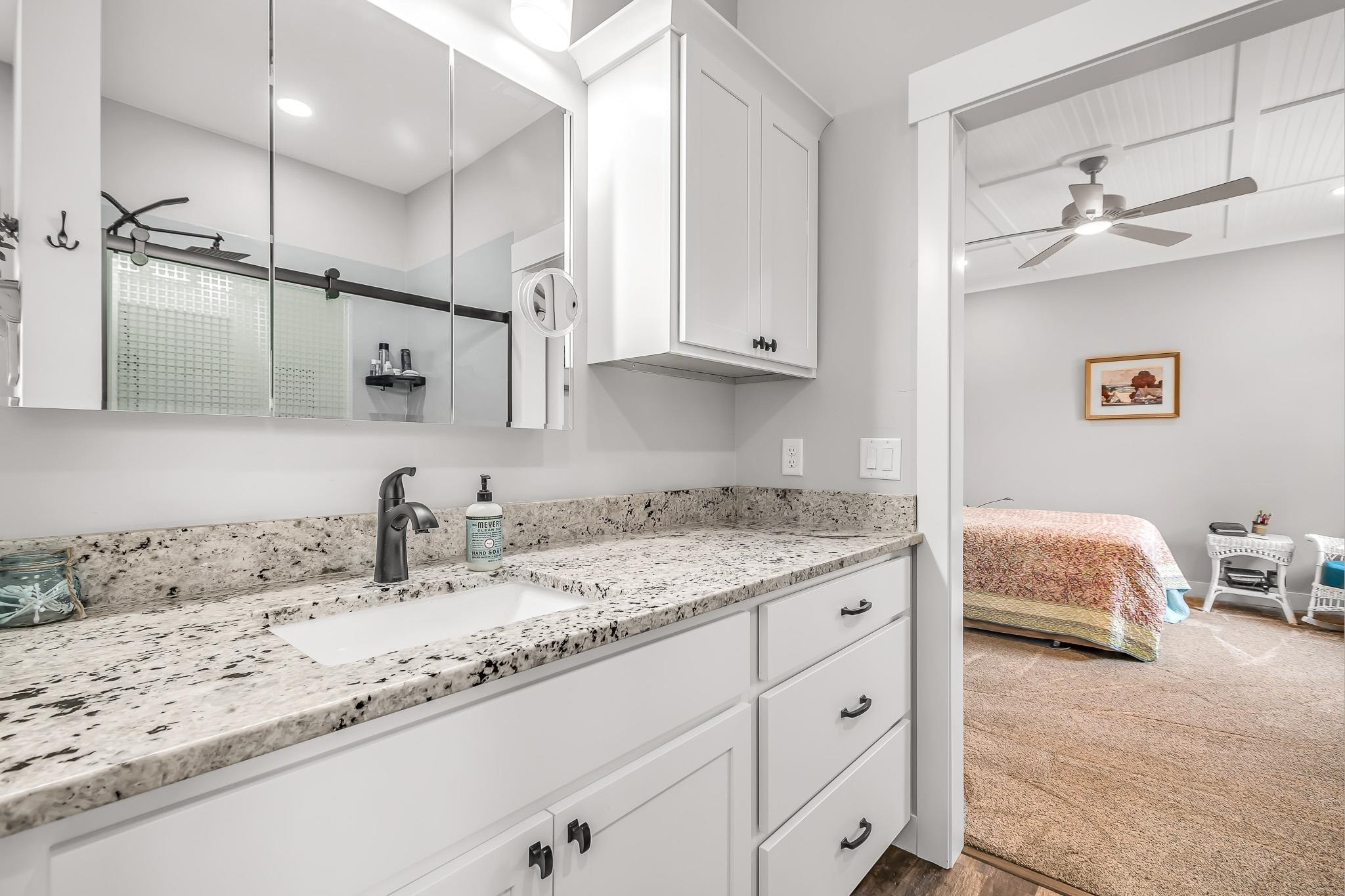 1171 20 Road Fruita, CO 81521 - Photo 31 of 42 a en suite bathroom with a granite countertop sink and a mirror
