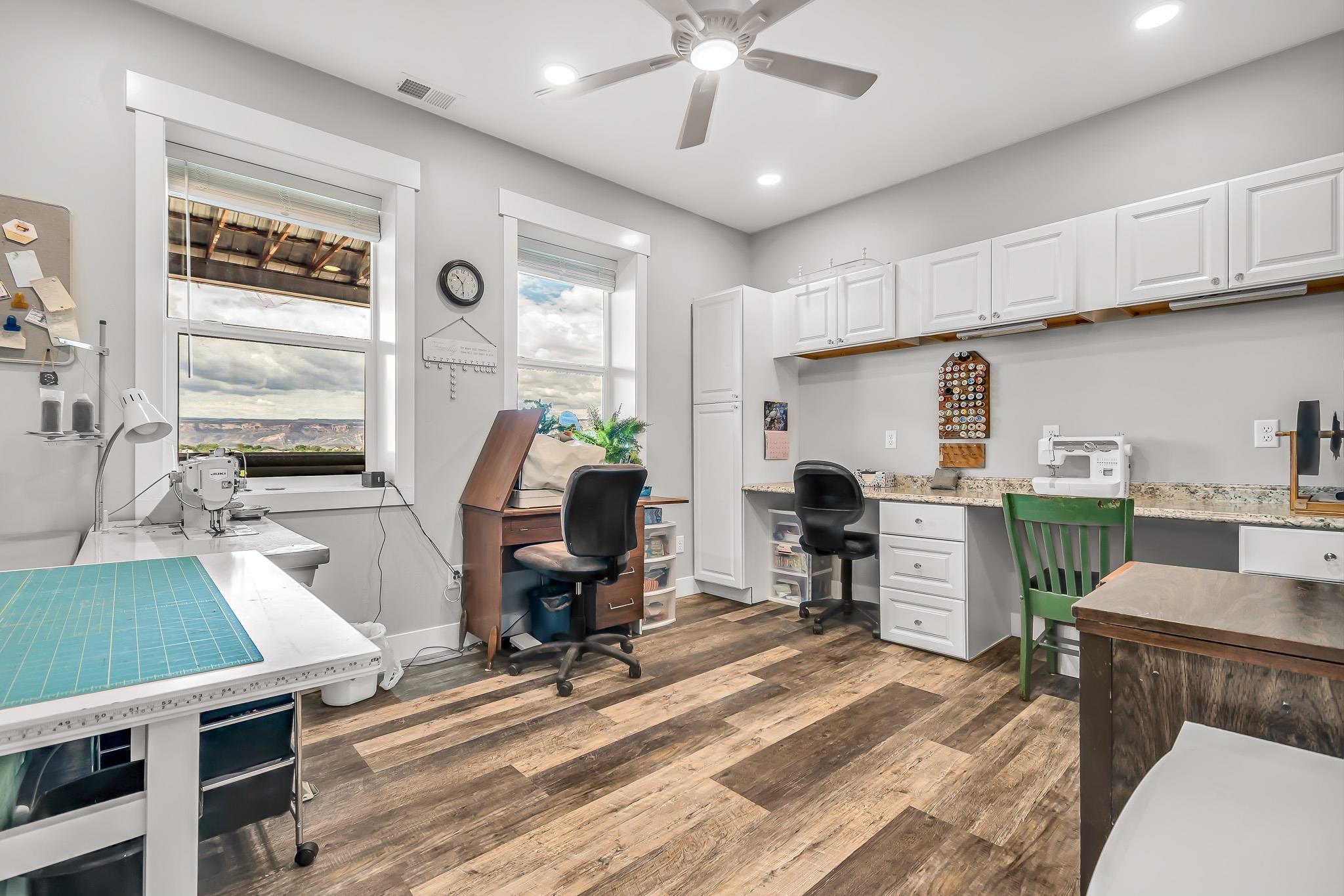 1171 20 Road Fruita, CO 81521 - Photo 32 of 42 a work room with furniture a rug potted plant and a window