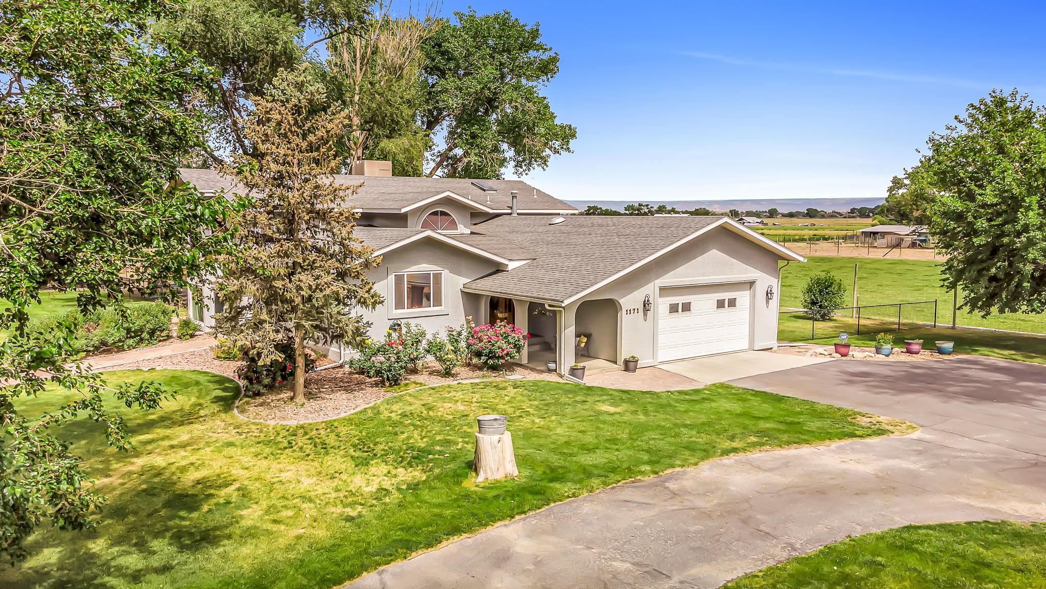 1171 20 Road Fruita, CO 81521 - Photo 42 of 42 a front view of a house with a yard and porch