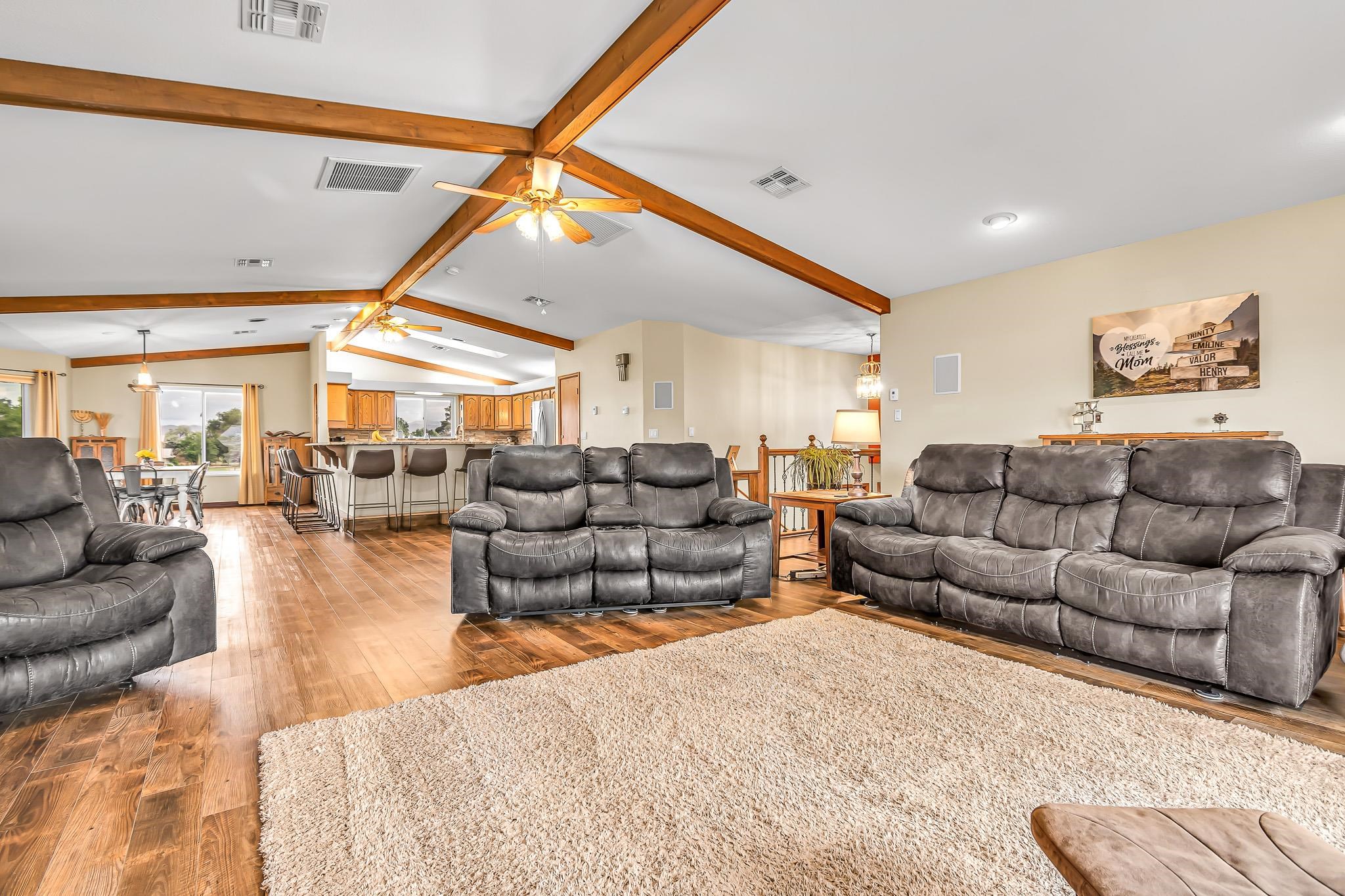 1171 20 Road Fruita, CO 81521 - Photo 7 of 42 a living room with furniture a ceiling fan and a rug