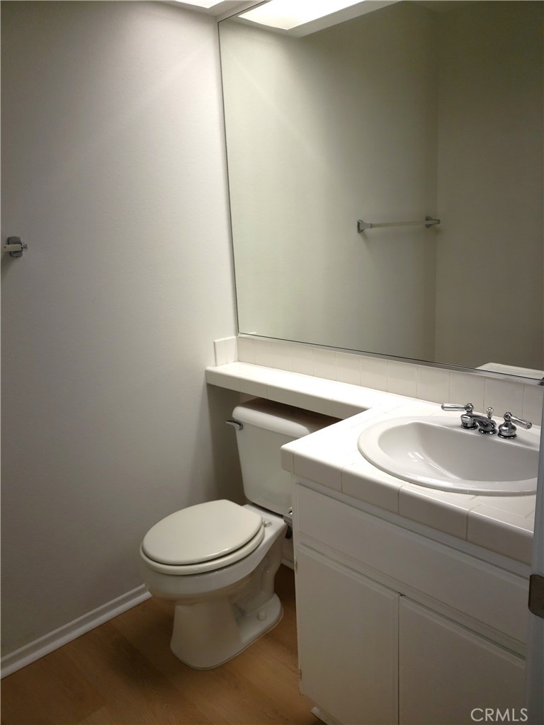 2345 Tryall Tustin, CA 92782 - Photo 19 of 29 a bathroom with a sink a toilet and mirror