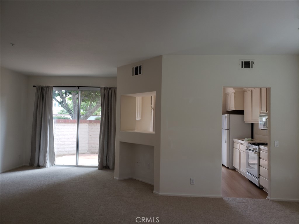 2345 Tryall Tustin, CA 92782 - Photo 4 of 29 a view of empty room with wooden floor and cabinet