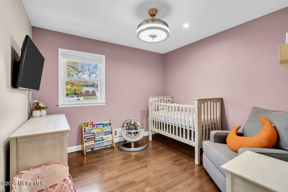 37 Glenbrook Road Freehold, NJ 07728 - Photo 13 of 34 a bedroom with furniture and a wooden floor