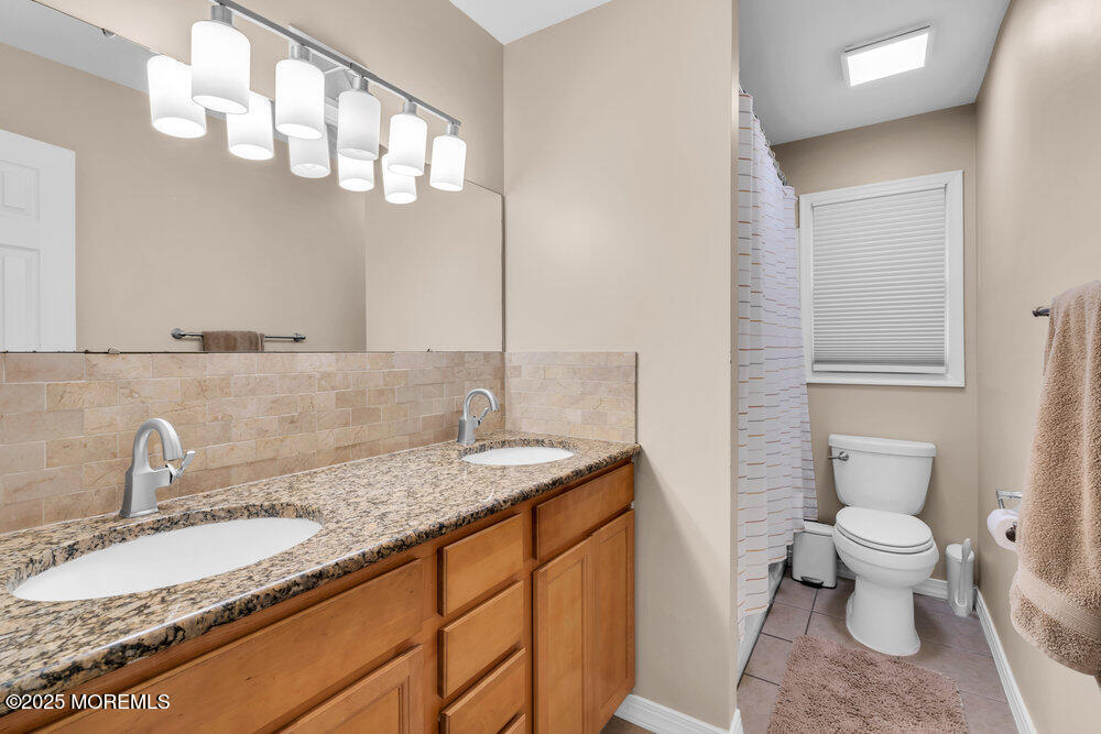 37 Glenbrook Road Freehold, NJ 07728 - Photo 15 of 34 a bathroom with a granite countertop sink a toilet and a mirror