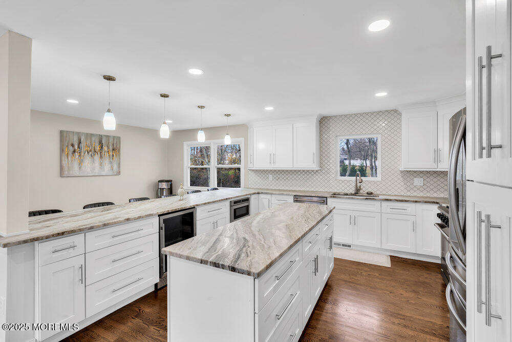 37 Glenbrook Road Freehold, NJ 07728 - Photo 19 of 34 a large white kitchen with cabinets a sink a window and stainless steel appliances