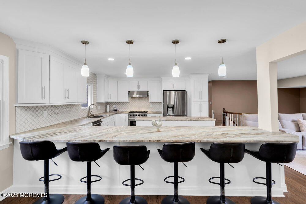 37 Glenbrook Road Freehold, NJ 07728 - Photo 23 of 34 a kitchen with a dining table and chairs