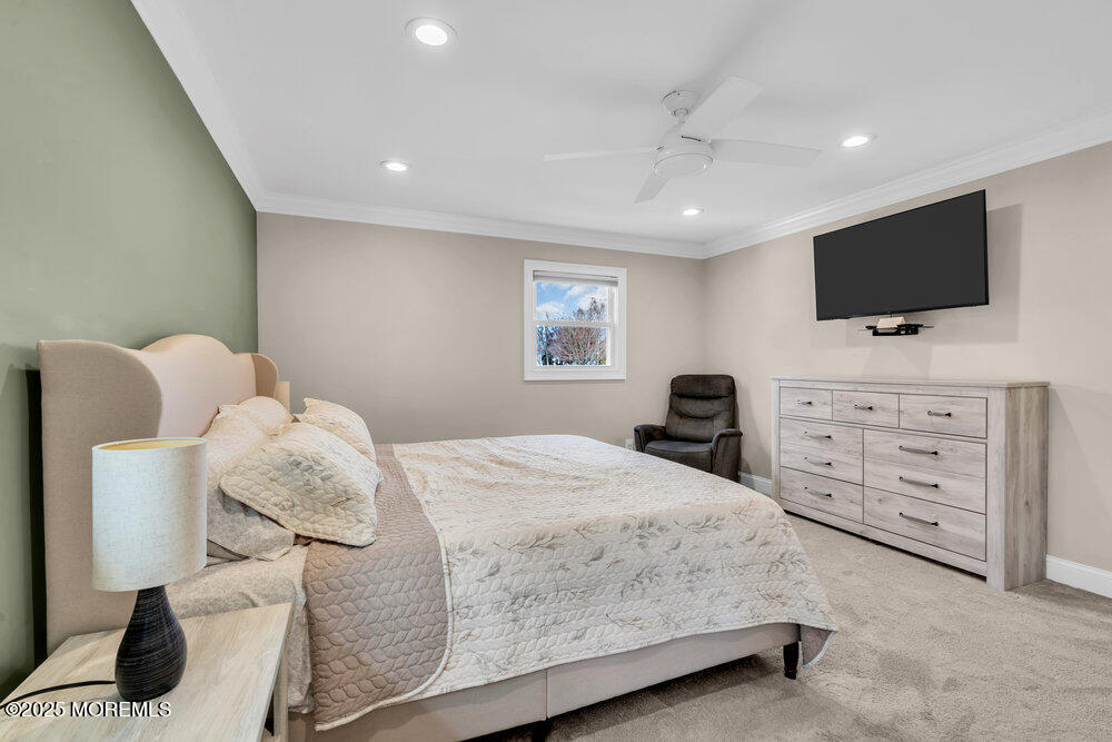 37 Glenbrook Road Freehold, NJ 07728 - Photo 28 of 34 a bedroom with a large bed and a flat screen tv