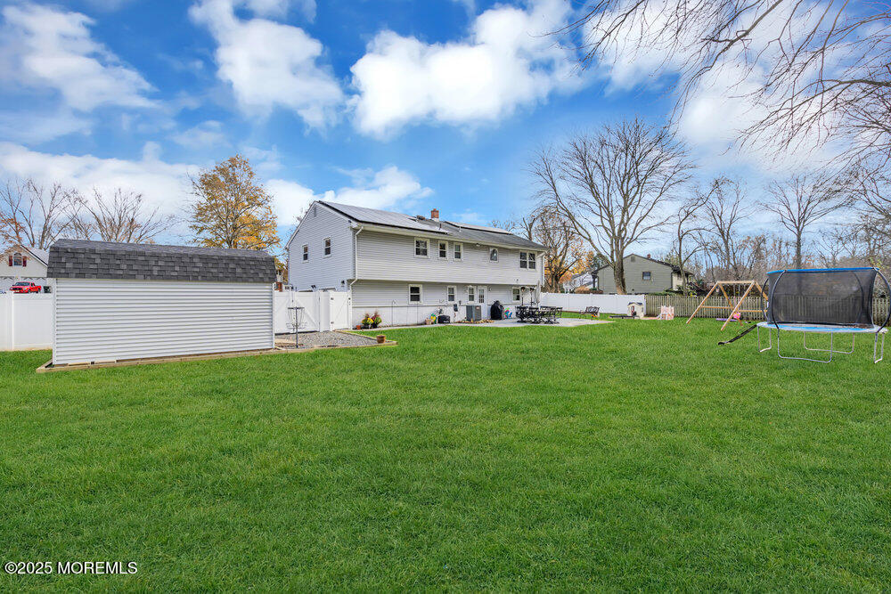 37 Glenbrook Road Freehold, NJ 07728 - Photo 29 of 34 a view of a white house with a big yard and large trees